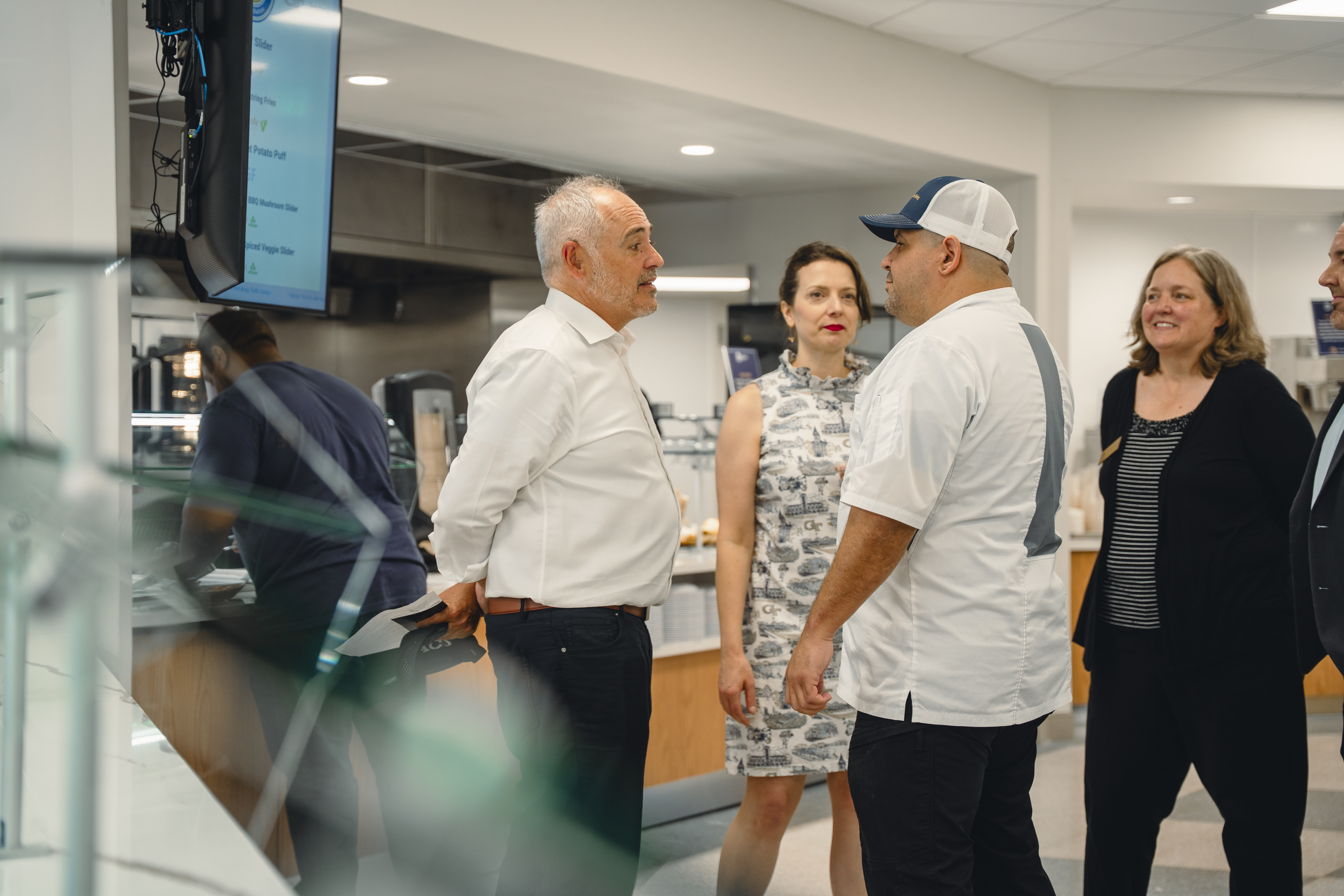 people talking to a chef
