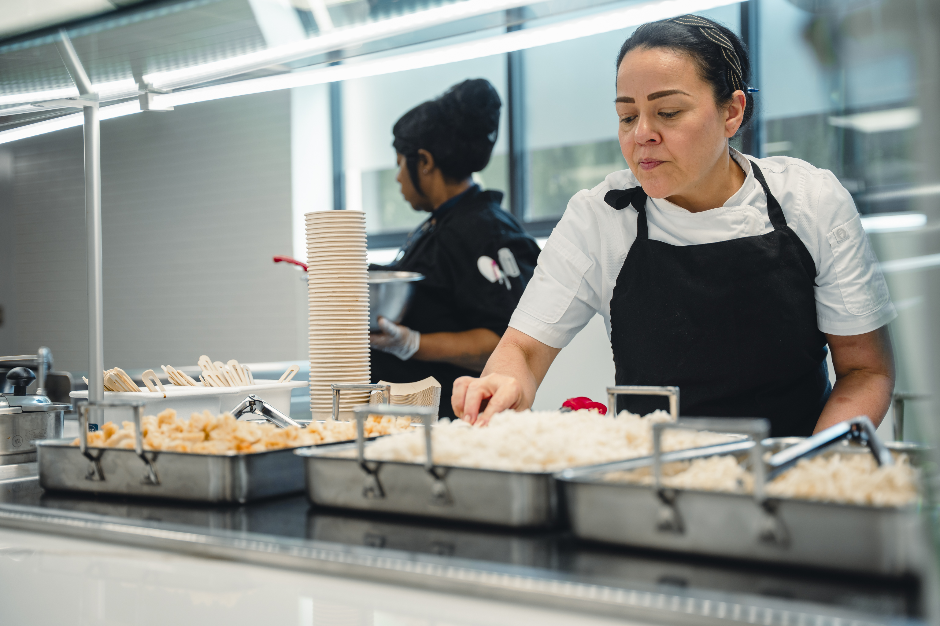 chef preparing food on a serving line