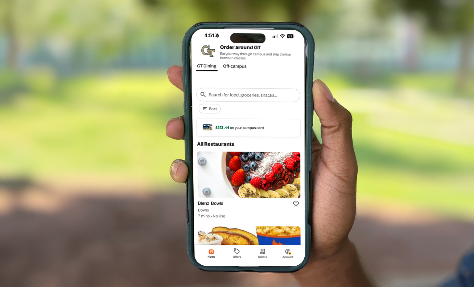 image of a person holding their phone with the grubhub app open