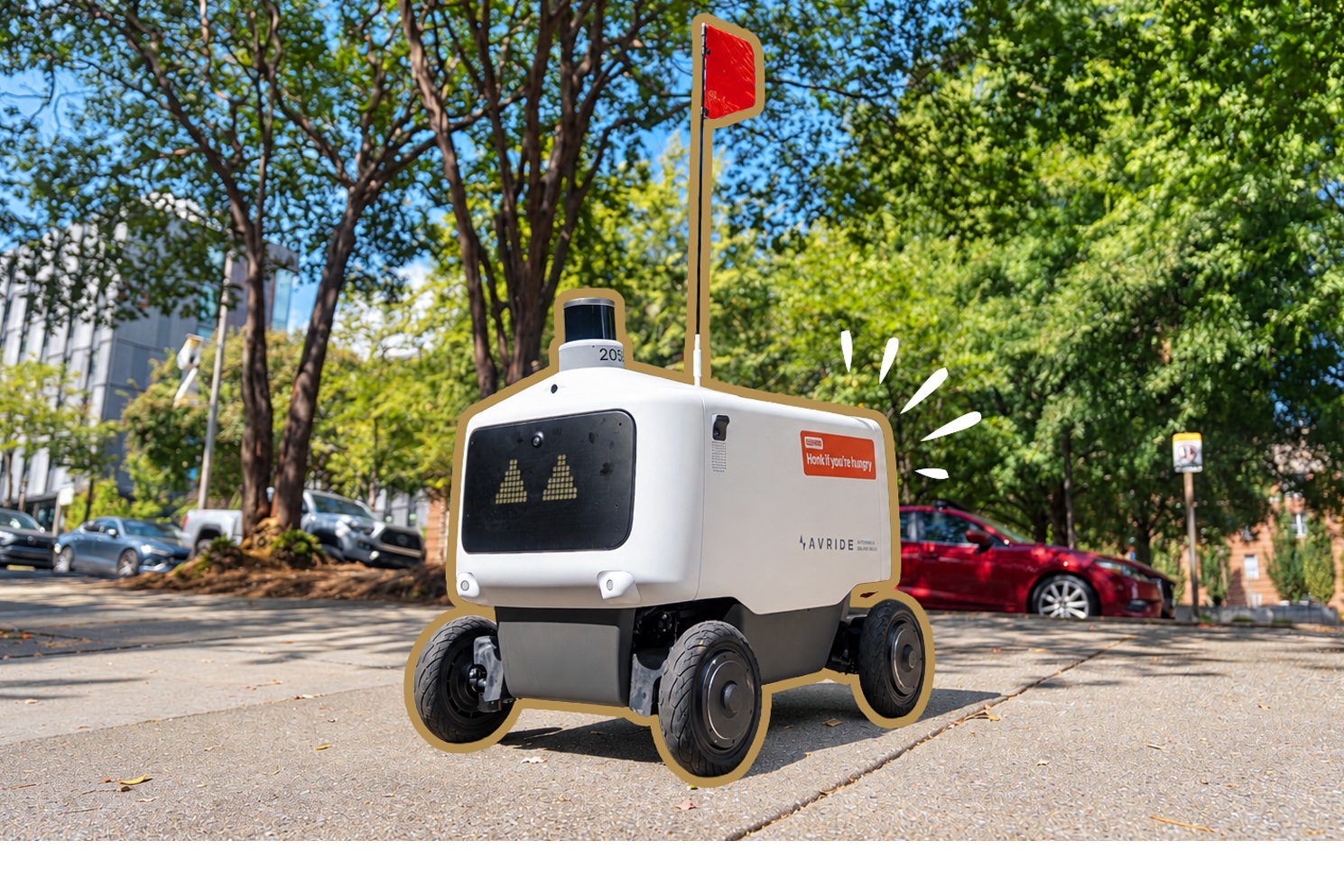 autonomous delivery robot on leafy sidewalk