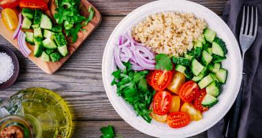 Healthy Quinoa Tabbouleh Salad bowl with fresh cucumbers, tomatoes and red onions